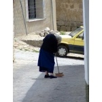 Woman sweeping the street. Photo by Alan Miller. All rights reserved.